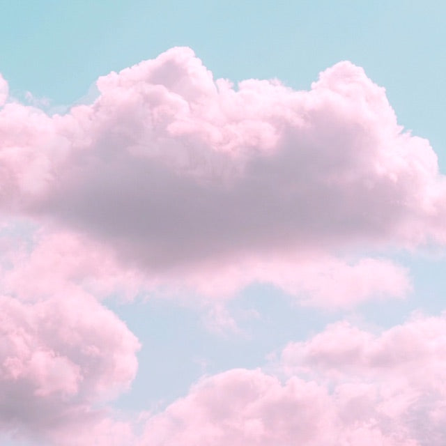 pastel pink clouds against light blue sky