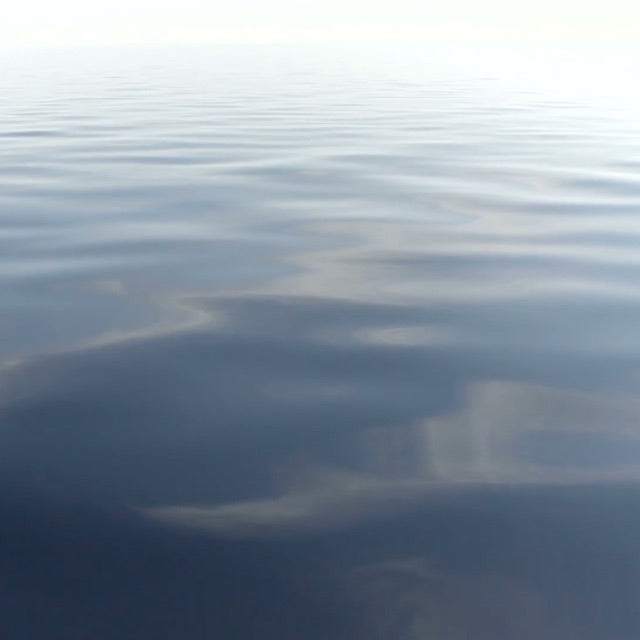 close up of smooth blue water surface with ripples