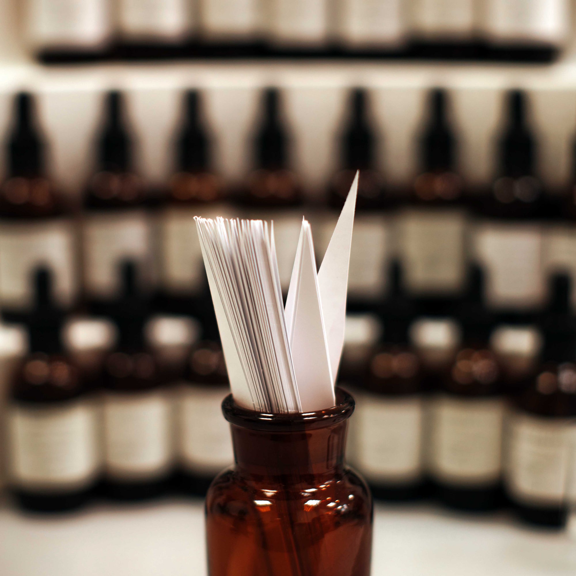 fragrance blotters in brown perfumer's bottle